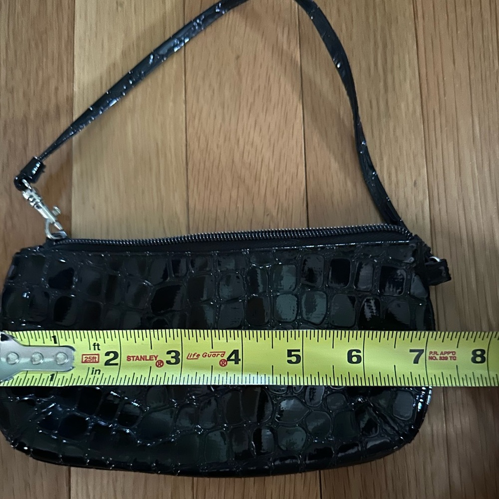 Black Patent Leather wristlet. Fits cellphone, cash, credit cards and lipstick.